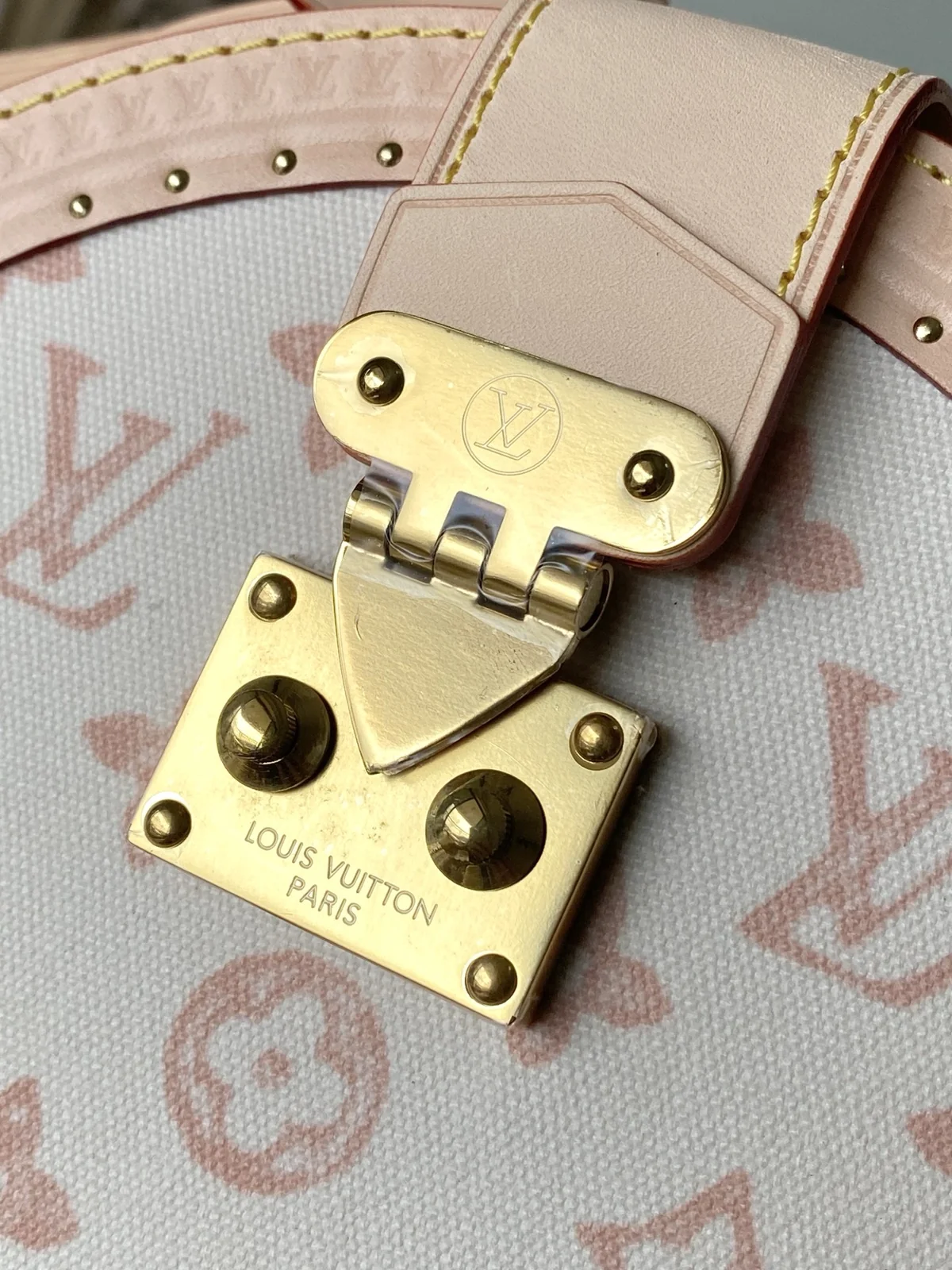 Close-up of LV brass lock hardware on Boîte Chapeau